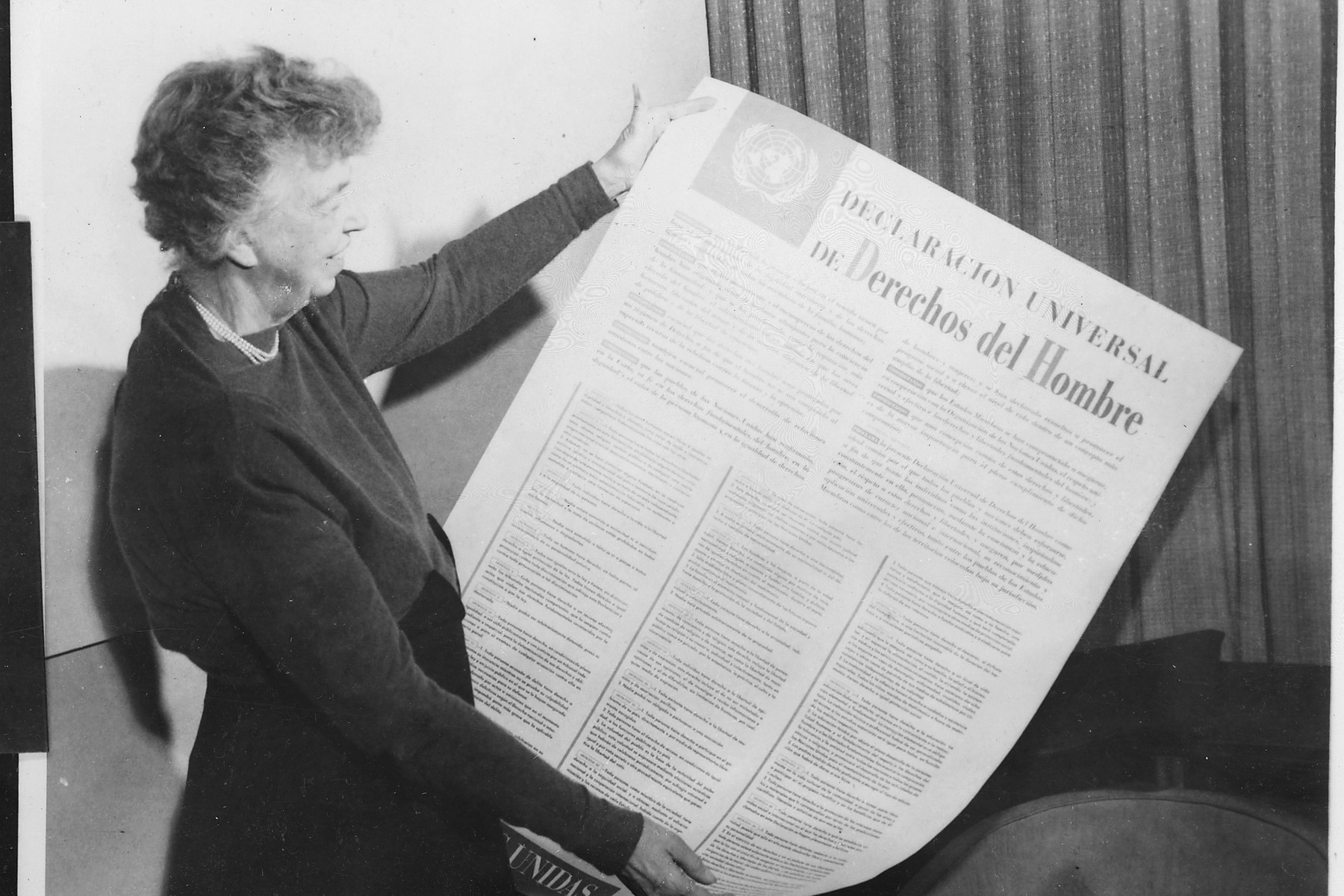 Eleanor Roosevelt holds the Universal Declaration of Human Rights in Spanish.