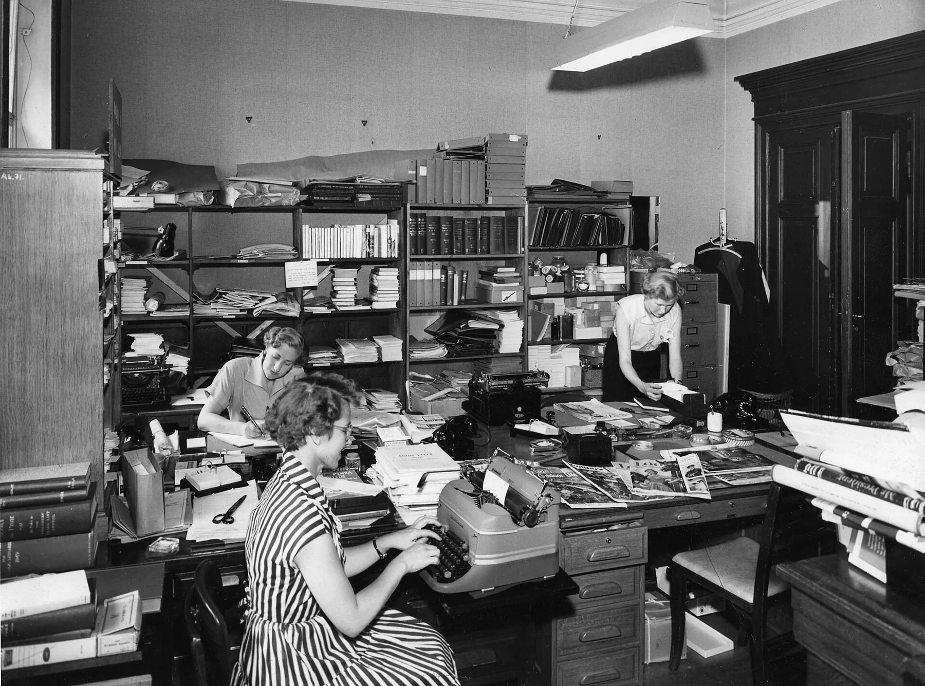 America Center Library historical photo of office workers, an archival visual related to How Did the Modern Office Come Into Existence.