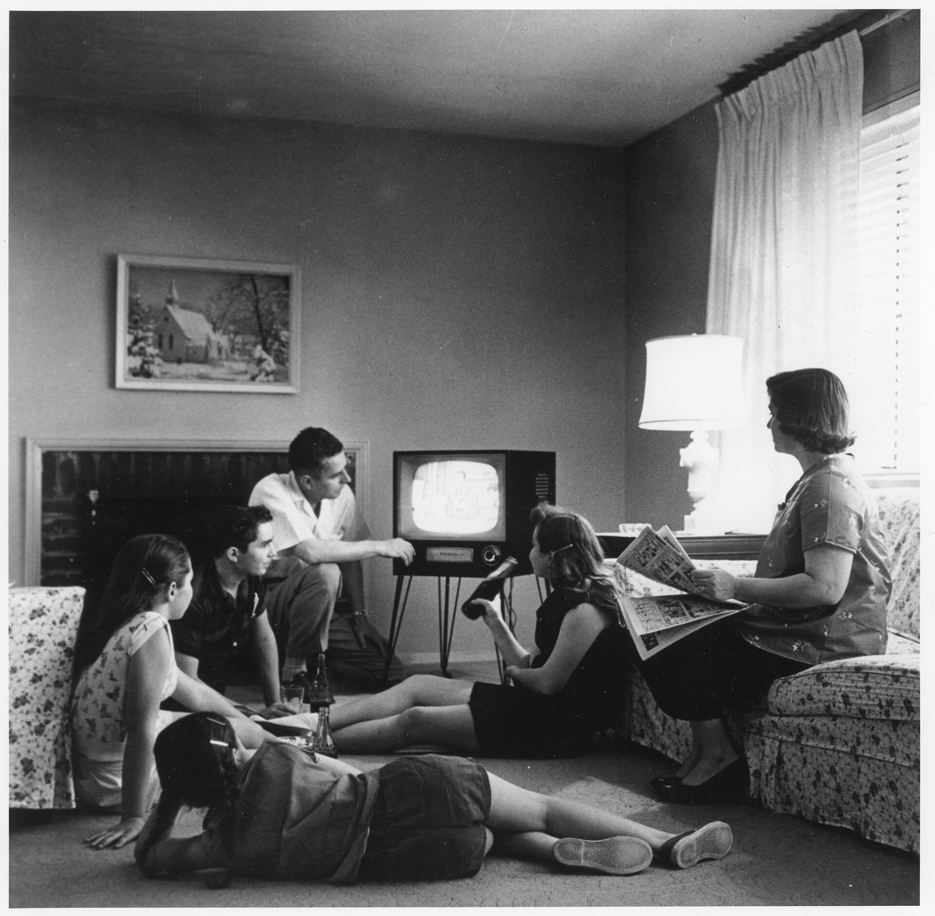 An American family gathered around a television in 1958.