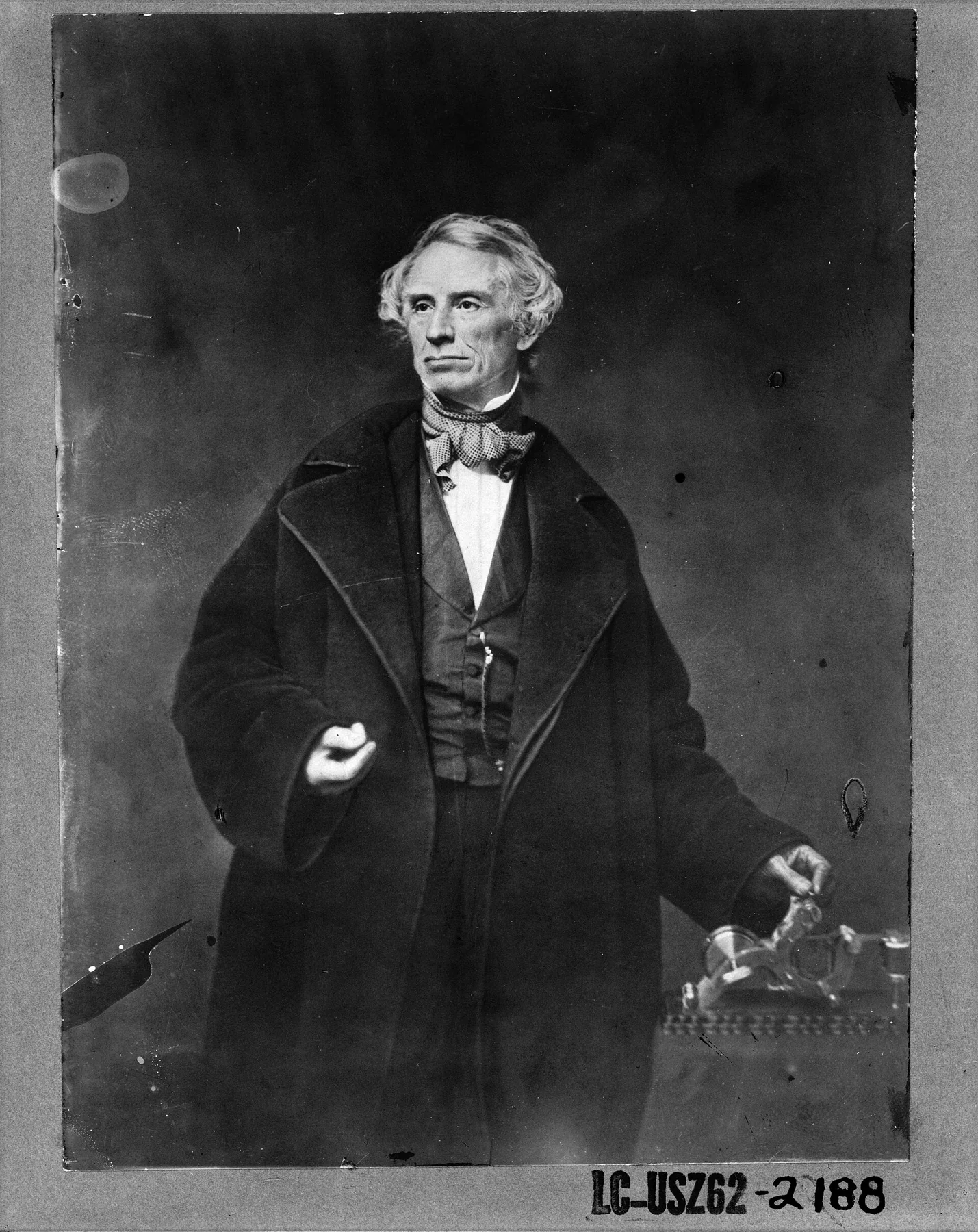 Samuel F.B. Morse, half-length portrait, posing with left hand on a telegraph apparatus, facing slightly left LCCN2001700118, an archival visual related to The Invention That Changed How We Communicate.