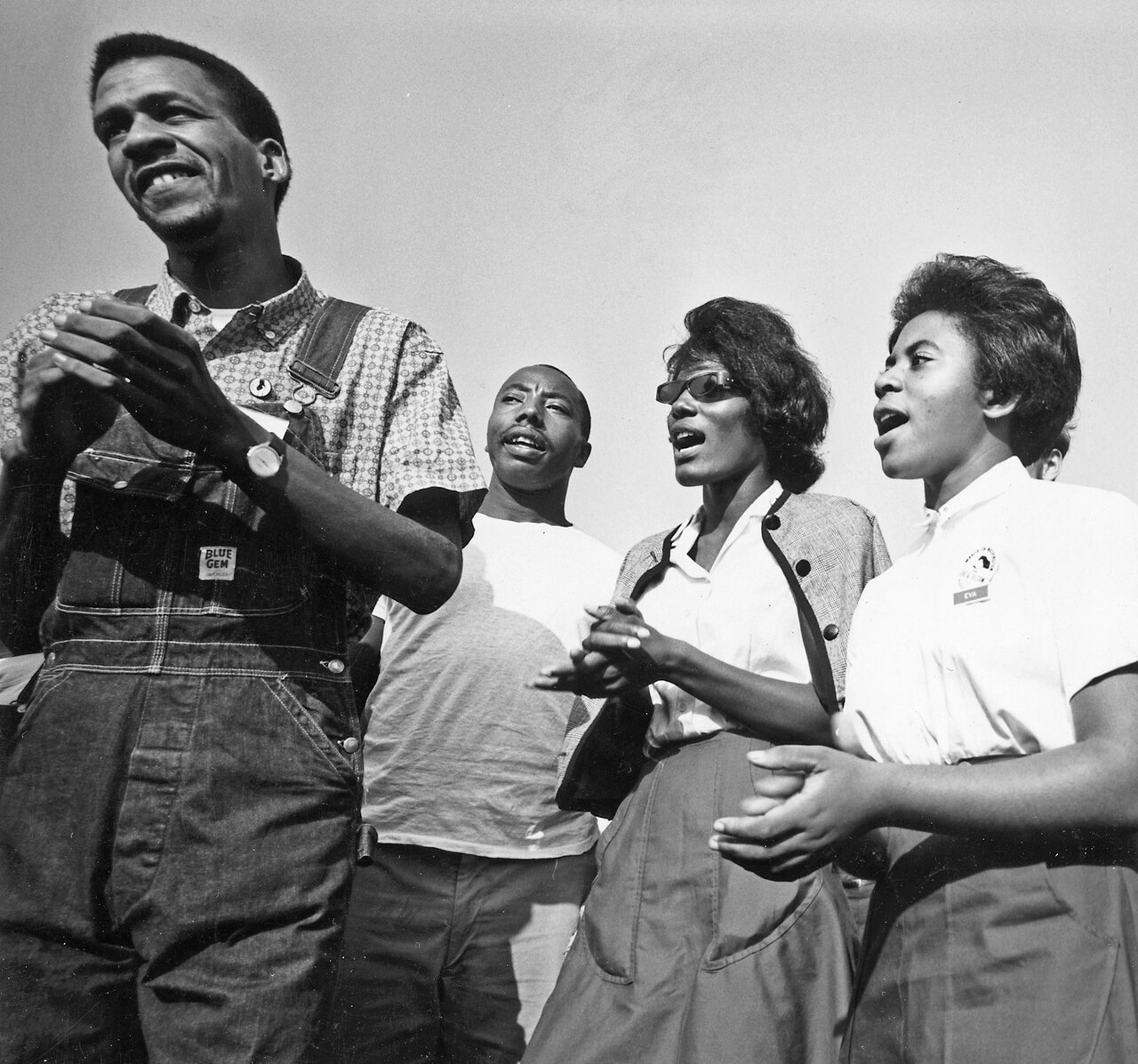 Four young marchers singing at the 1963 Civil Rights March on Washington, D.C.