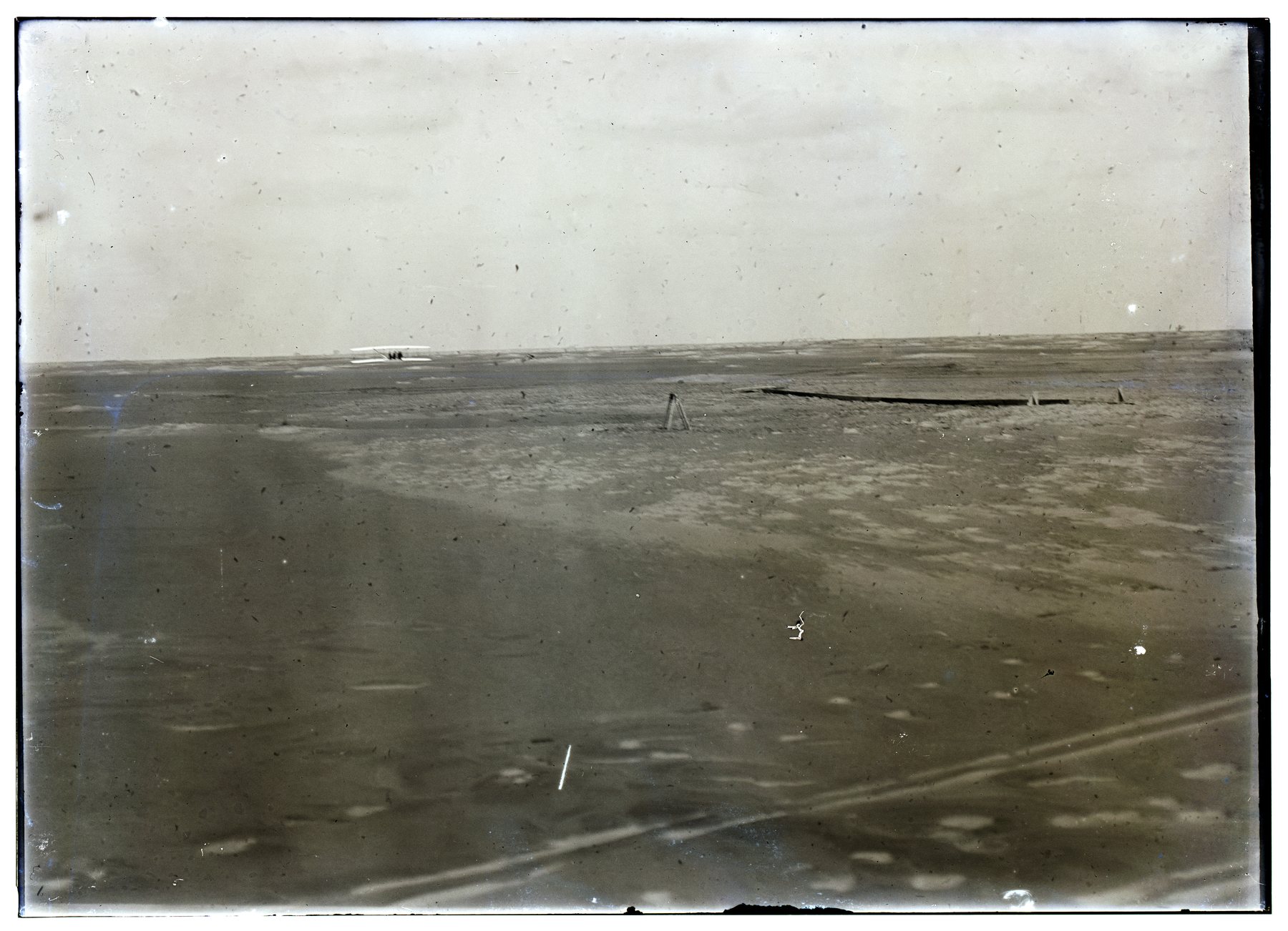 The Wright Flyer during its fourth flight at Kitty Hawk on 17 December 1903.
