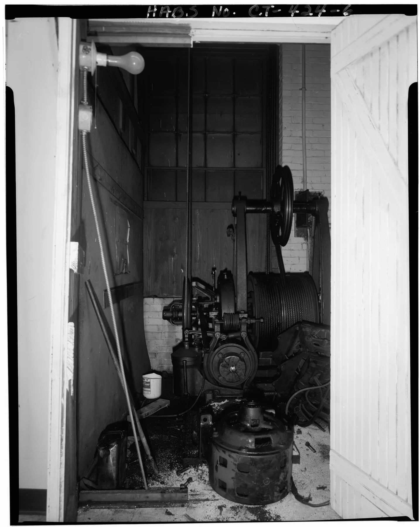 FIRST FLOOR, SOUTH SECTION, OTIS ELEVATOR MOTOR, c. 1910, VIEW NORTH. - 16-32 Spring Street (Commercial Building), Waterbury, New Haven County, CT, an archival visual related to Why Do We Have Elevators.