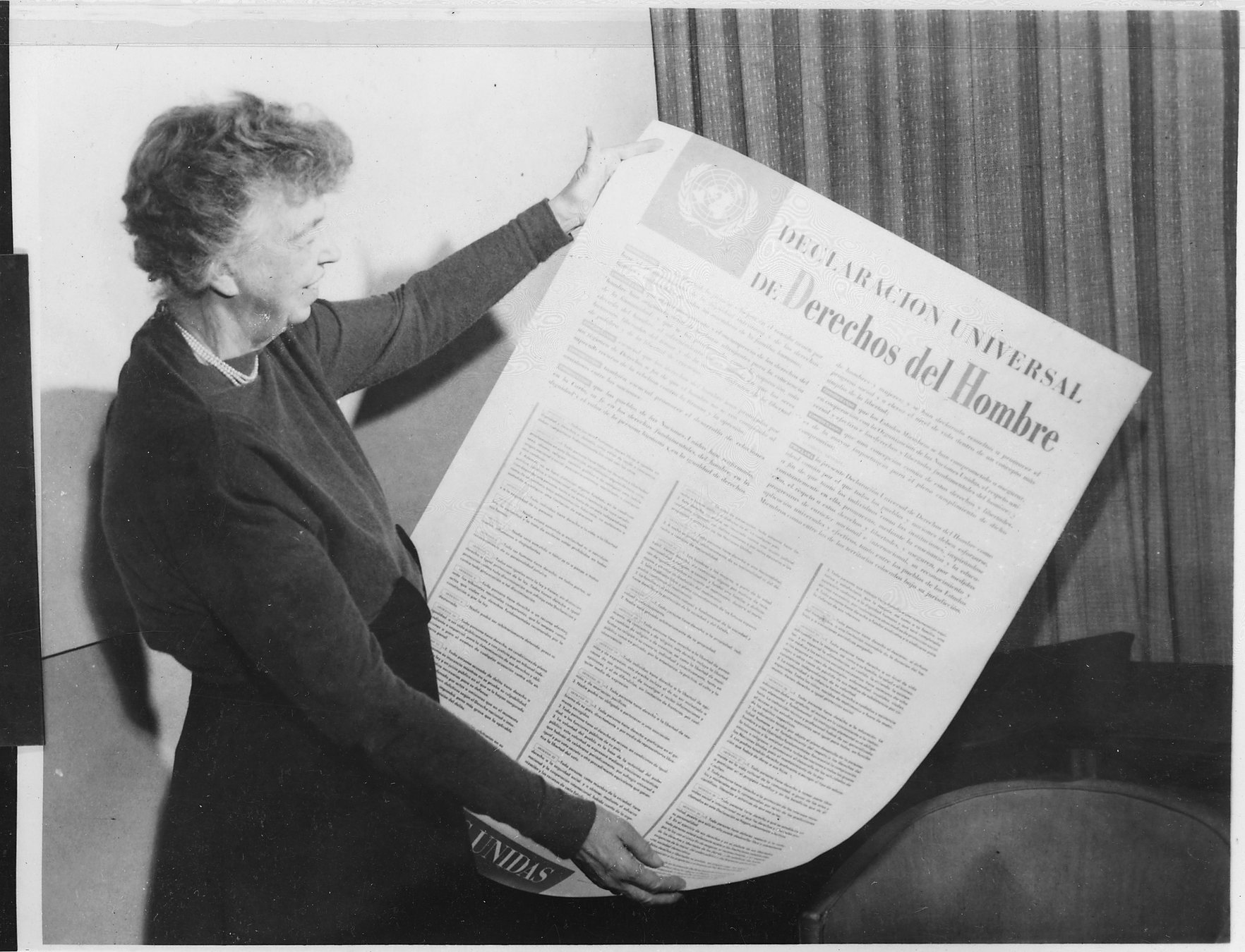 Eleanor Roosevelt holds the Universal Declaration of Human Rights in Spanish.