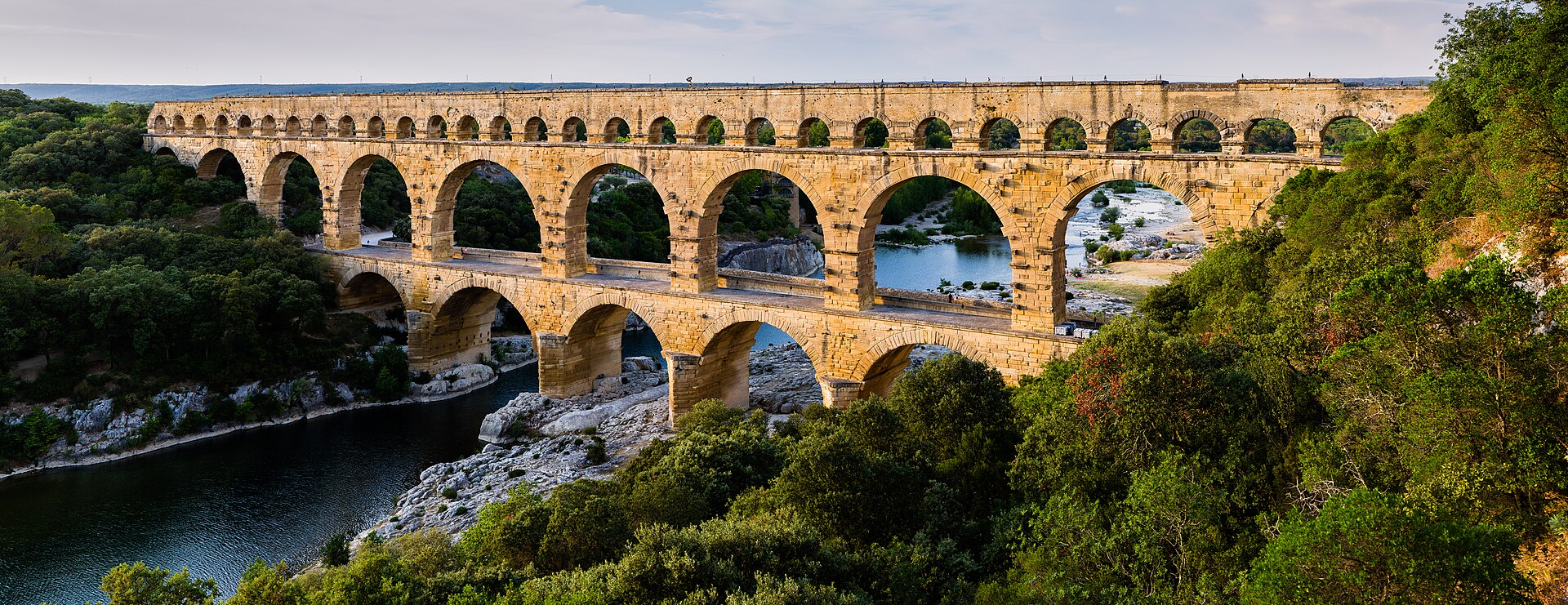 Three tiers of Roman stone arches spanning the Gardon River.