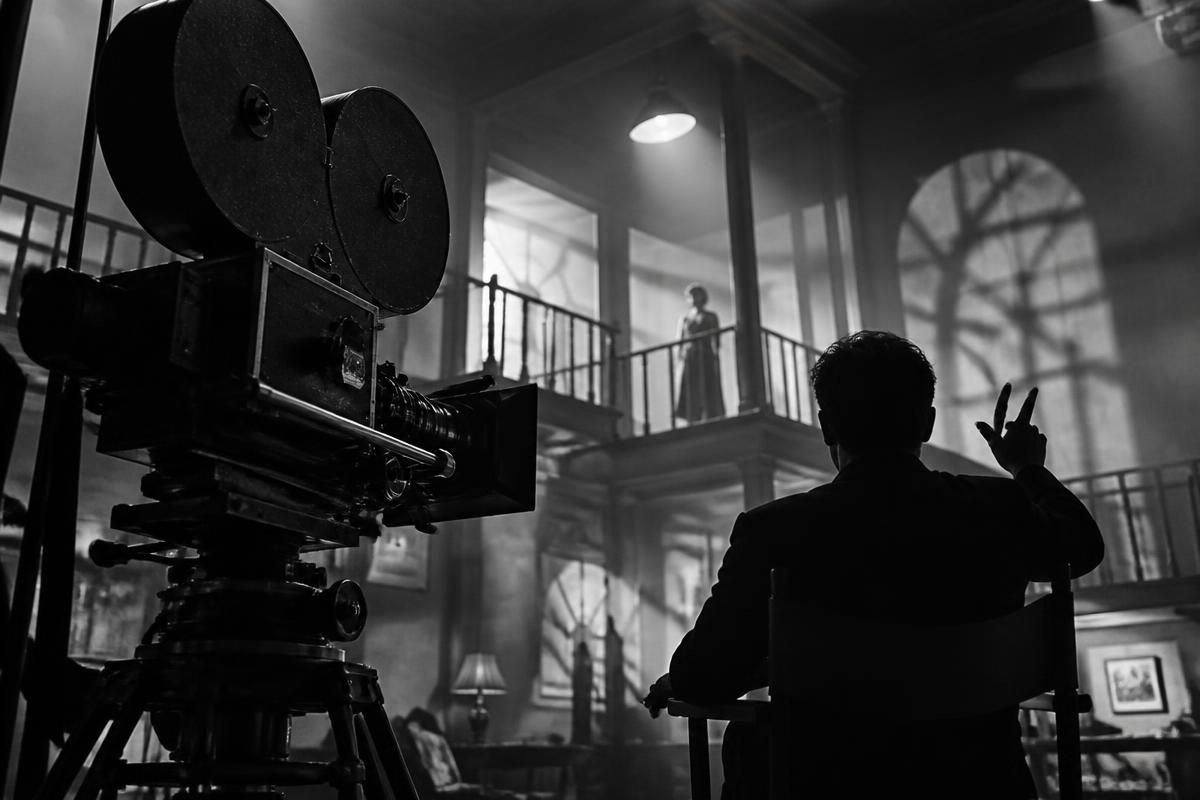 Original editorial illustration of a 1940s film camera and director using expressive composition.