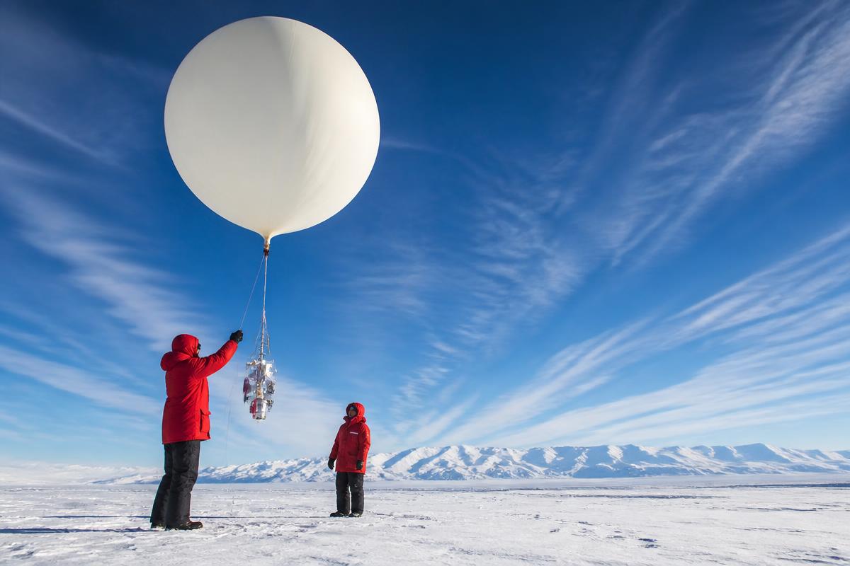 Original editorial illustration of atmospheric researchers launching an ozone-monitoring balloon.