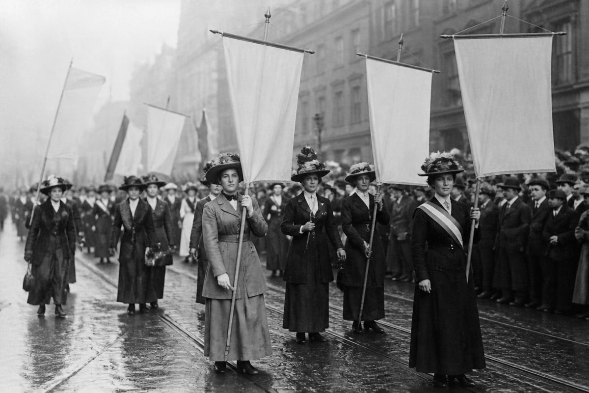 Original editorial illustration of an early twentieth-century women’s suffrage procession.